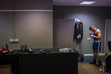 Laurence Mills prepares in the fighters area before his fight at a white collar boxing event at the London Irish Centre where the 'Carpe Diem' boxing event is taking place.   'White-collar boxing' is...