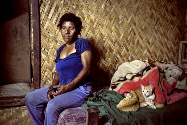 Wendi, from Chimbu Province, in her house. In 2011 she was accused of sorcery and brutally attacked and tortured by villagers for three days.