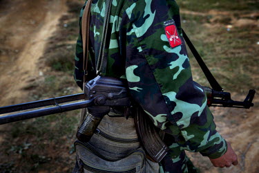 A Shan State Army - South rebel soldier walks through Bang Laem Village in a Shan State Army - South controlled area of Shan State.