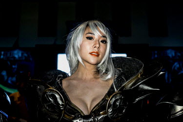A Cosplayer dressed as her favorite Japanese Anime character poses for photos at a mall in Bangkok. Cosplay is short for Costume Play.  It's essentially role playing and usually involves people dressi...