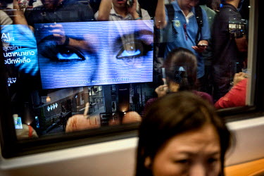 Large monitors play advertisements along the Skytrain track.  ~<i>This is Bangkok</i> Globalised and localised.  Everyone is plugged into something. Cosplay from Japan. Pop from Korea. Products from C...