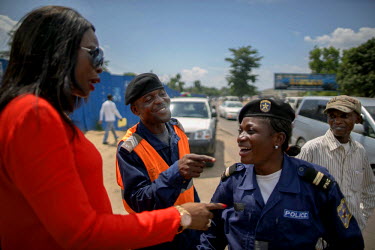 Therese Kirongozi (left), speaks to Kinshasa traffic police officers. Women's Tech, a small enterprise started by Therese Kirongozi, a local entrepreneur, manufactures humanoid traffic robots that are...