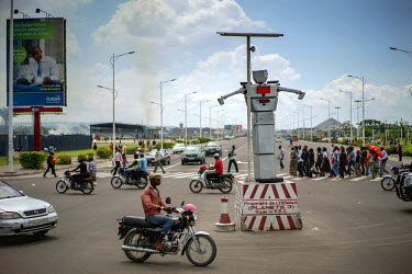 An 8 foot tall humanoid traffic robot equipped with a rotating chest and video cameras controls and monitors traffic on a busy road in Kinshasa. Built by Women's Tech, a small enterprise started by Th...