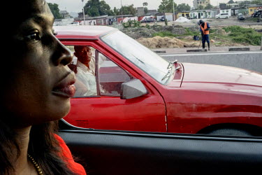 Therese Kirongozi driver in her car through the city. Women's Tech, a small enterprise started by Therese Kirongozi, a local entrepreneur, manufactures humanoid traffic robots that are intended to ble...
