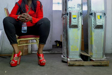 Therese Korongozi, owner of Women's Tech, sits next to parts of the traffic robots her company produces in the workshop behind a restaurant which she owns. Women's Tech, a small enterprise started by...