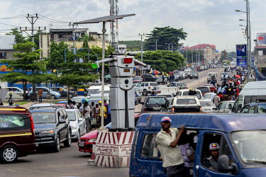 An 8 foot tall humanoid traffic robot equipped with a rotating chest and video cameras controls and monitors traffic on a busy road in Kinshasa. Built by Women's Tech, a small enterprise started by Th...