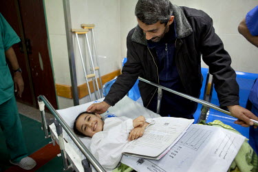 Weam Al Astal, a nine year old from Khan Younes, with her father as she prepares to undergo surgery after she received serious injuries during the summer 2014 Israeli military operation ('Pillar of De...