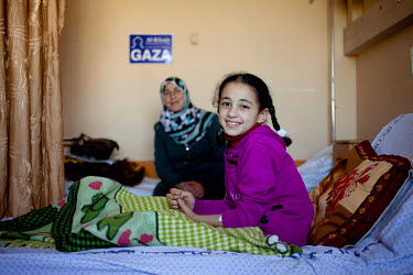 Weam Al Astal, a nine year old from Khan Younes, talks with her mother after undergoing surgery to treat serious injuries she received during the summer 2014 Israeli military operation ('Pillar of Def...