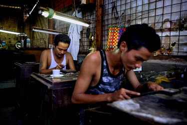 Burmese workers making jade jewellery in a workshop at the Jade Market in Mandalay.