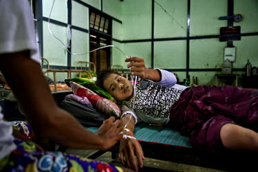 A recovering heroin addict adjusts his saline drip in a government drug rehabilitation facility. Kachin state, where most of Myanmar's jade comes from, has some of the highest rates of heroin use and...