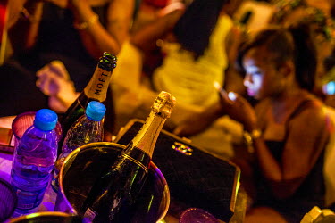 Champagne bottles and a Channel bag among the revellers at the Voodoo bar and night club on Elegushi Beach, Lekki.
