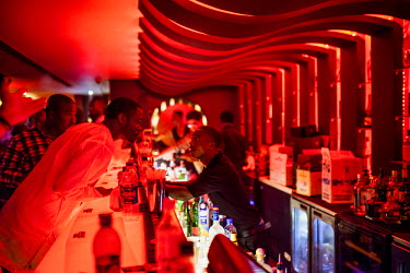 People order drinks from the bar the Spice Route night club on Victoria Island.