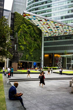 People walk past the Ocean Financial Centre vertical garden in the heart of the Central Business District in downtown Singapore. The Vertical Garden at Ocean Financial Centre is the largest potted sys...