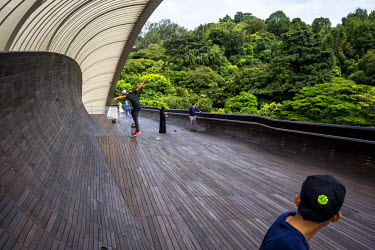 A group of Singaporean youths skateboard on Henderson Waves bridge, Singapore's highest pedestrian bridge built 36 meters above the road.With a growing urban population, high-rise buildings are an inc...