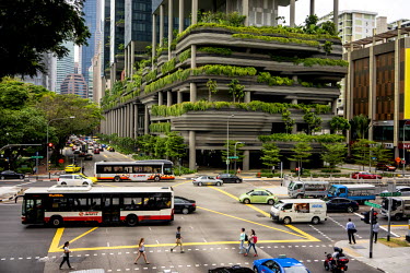 Pedestrians walk past the Parkroyal hotel which claims to have a total foliage cover of more than 200% of the structure's total land area, effectively using vertical greenery to replace the original g...