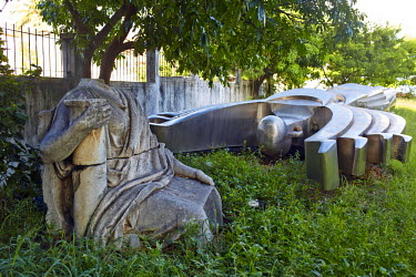 Abandoned public sculptures dumped on waste ground. The big metal structure was brought by the Chinese who built the new national stadium in Zimpeto. They had placed it at the main entrance and the go...