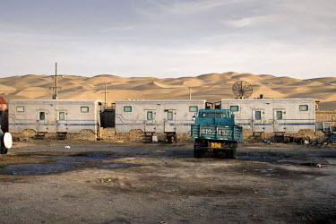 Oil-worker's mobile homes, fixed on brick foundations, at a camp deep within the Taklaman Desert. At the camp highly qualified workers, such as engineers and topographers, stay in a basic hotel, while...