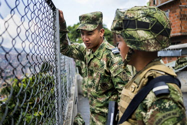 Members of an army unit stationed in Comuna 13, the most dangerous district in Medellin, Colombia. There are eight bases with 140 soldiers in the district. In 2006, the city built a public library, a...