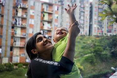 Francenny Acevedo, 14, plays with her cousin, Derick Yisslan 2, on their balcony in Nuevo Occidente, a massive social housing complex of mostly displaced or forcibly evicted families in Medellin. 18 f...