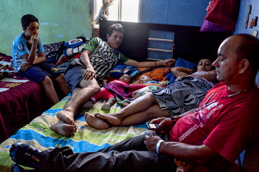Gloria Acevedo Restrepo's family in Nuevo Occidente, a massive social housing complex of mostly displaced or forcibly evicted families in Medellin. 18 family members live in a 70 square meter apartmen...