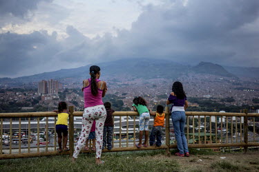 Residents take in the view at the top of the 'hill', a former rubbish dump turned into a garden. Since 2012, the city of Medellin has adopted an innovative project in the neighbourhood of Moravia to t...