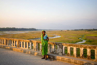 A woman stands on the Mechi bridge which connects India and Nepal near the Panitanki border post. The border point is one of the main smuggling routes for tiger parts trafficking between India and Chi...