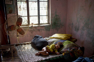 A boy belonging to the Babaria caste sleeps on a bed. The Babaria are a major source of illegally traded tiger parts since they used to hunt them when it was legal to do so and now sell them to traffi...