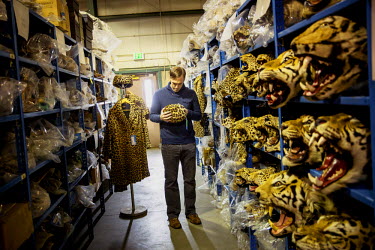 A man looks at a hat made out of leopard skin in a repository of the U.S. Fish & Wildlife Service where animal parts are stored that have been seized by US Customs.