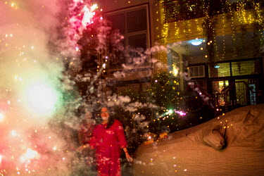 People set off fireworks in the street on the occasion of Diwali, one of the biggest festival for Hindus.