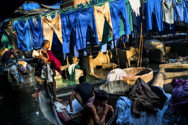Dhobis (laundry person) washing hospital uniforms in Dhobighat, the open air area where the city's laundry is washed by an army of dhobis. Here they wash, by hand, the laundry for all strata of the ci...