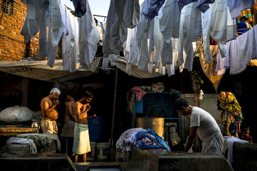 Washermen (locally known as Dhobis) brush their teeth while others wash clothes in Dhobighat. This is an open air area where 'dhobis' wash the laundry for all strata of the city's society. It is here...