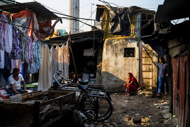 A woman sits outside her hut in Dhobighat where hundreds of families live doing the laundry work that they have made their living by for many generations. Dhobighat is an open air area where 'dhobis'...