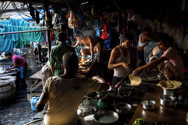 Washermen (known as Dhobis) gather to cook rotis for breakfast in Dhobighat. It is here that the laundry for all strata of the city's society is washed by hand. From hospital sheets to hospitality tab...