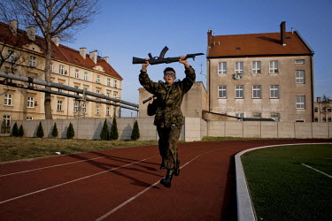 Young members of Strzelec (The Shooter), a paramilitary association, training with dummy guns on the playing field of a local school. The weekend saw a gathering of several paramilitary groups from th...