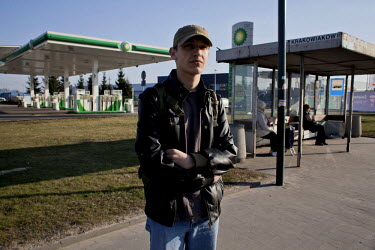 Mateusz a member of Strzelec (The Shooter), a paramilitary association, waiting for a bus. Since the start of war in Ukraine, membership of paramilitary associations has grown.