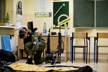 Kamilla, 17, a young member of Strzelec (The Shooter), a paramilitary association, gets herself ready during a training weekend. Several paramilitary groups from the region joined together to take par...