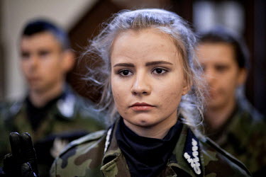 A young female member of Strzelec (The Shooter), a paramilitary association, during an oath taking ceremony. Since the start of war in Ukraine, membership of paramilitary associations has grown.