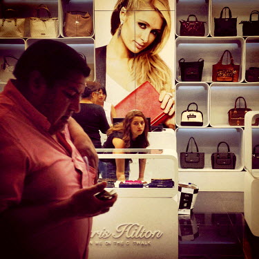 People shop for bags at a Paris Hilton store in the Scala Mall.