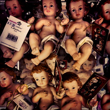 Doll figures representing a baby Jesus are sold for Christmas in Santa Maria, a supermarket in Tumbaco.