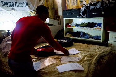 Siyakudumisa Vapi, a licensed boxer who hopes to make it as a professional, arranges his CV and qualifications on his bed before heading out into the city to look for work. Currently living in a curta...