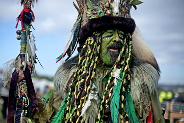 A reveller at a Jack in the Green festival. The festival is part of a recent revival of an older custom where people would wear frameworks covering much of their bodies which were decked out in foliag...