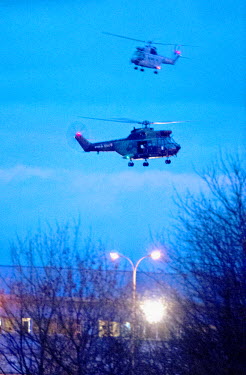 French military helicopters fly above an industrial estate in the village of Damartin-En-Goele where two Islamist terrorists, who had previously stormed the offices of satirical magazine Charlie Hebdo...