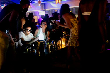 People drinking and chatting at the Seduction Nightclub, known as a popular destination for French tourists. According to the club's manager, it is the most successful club in Thailand with clientele...