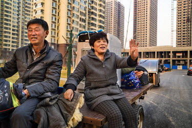 A couple who are moving into new 'relocation' housing greet their former village neighbours. In a move to increase the size of the middle class and boost demand, the government intends to move 100 mil...