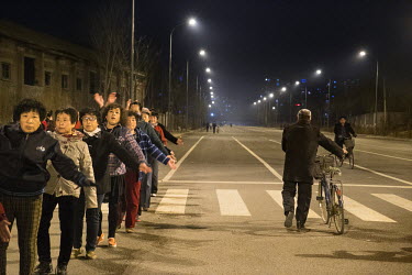 Residents take part in <i>Guang chang wu</i> or 'public space dance' in a 'replacement' housing estate. In a move to increase the size of the middle class and boost demand, the government intends to m...