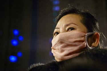 A woman wears a mask to avoid breathing in pollution caused by large scale construction projects nearby. In a move to increase the size of the middle class and boost demand, the government intends to...