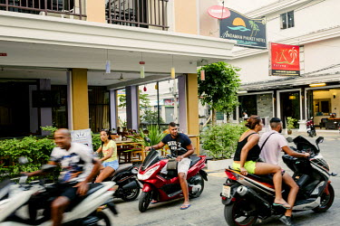 Tourists riding hired scooters in an area of Patong popular with French visitors and nicknamed La Courneuve, after a Parisien suburb.