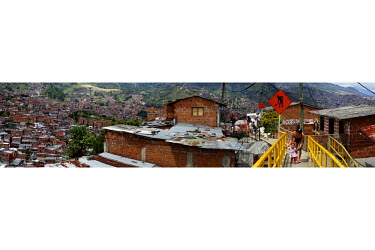 A mother and daughter walk along a bridge in Comuna 13, the most dangerous district in Medellin. There are eight bases with 140 soldiers in the district. In 2006, the city built a public library, a ne...