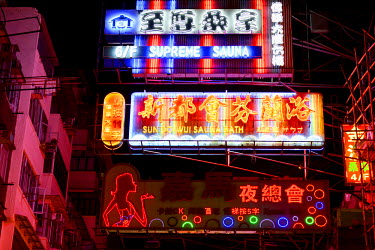 Neon signs, advertising sauna services and karaoke clubs, in the backstreets of the Mongkok District.