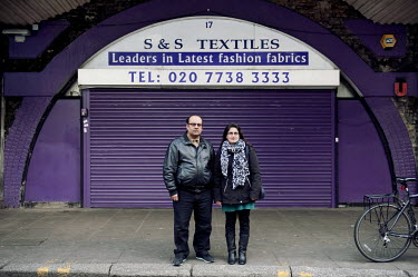 S & S Textiles, 17 Atlantic Road, London SW9 8HX.  Mr and Mrs Shafiq stand in front of their closed shop. They took over the premises 10 years ago but the shop has been there for over 35 years.   Prop...